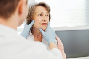 Attractive senior woman, patient talking to cosmetologist doctor,